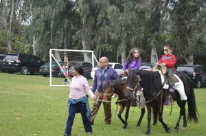 Tyler riding horses with his cousin